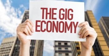 The GIG Economy placard with urban background