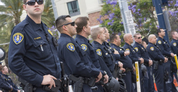 SAN DIEGO USA - MAY 27 2016: San Diego police officers stand on watch in an effort to keep the peace at an anti-Trump demonstration outside a Trump rally at the San Diego Convention Center.