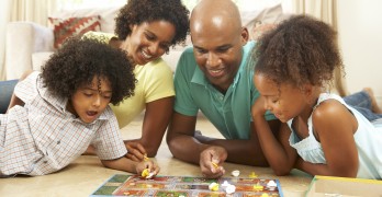 Family Playing Board Game At Home